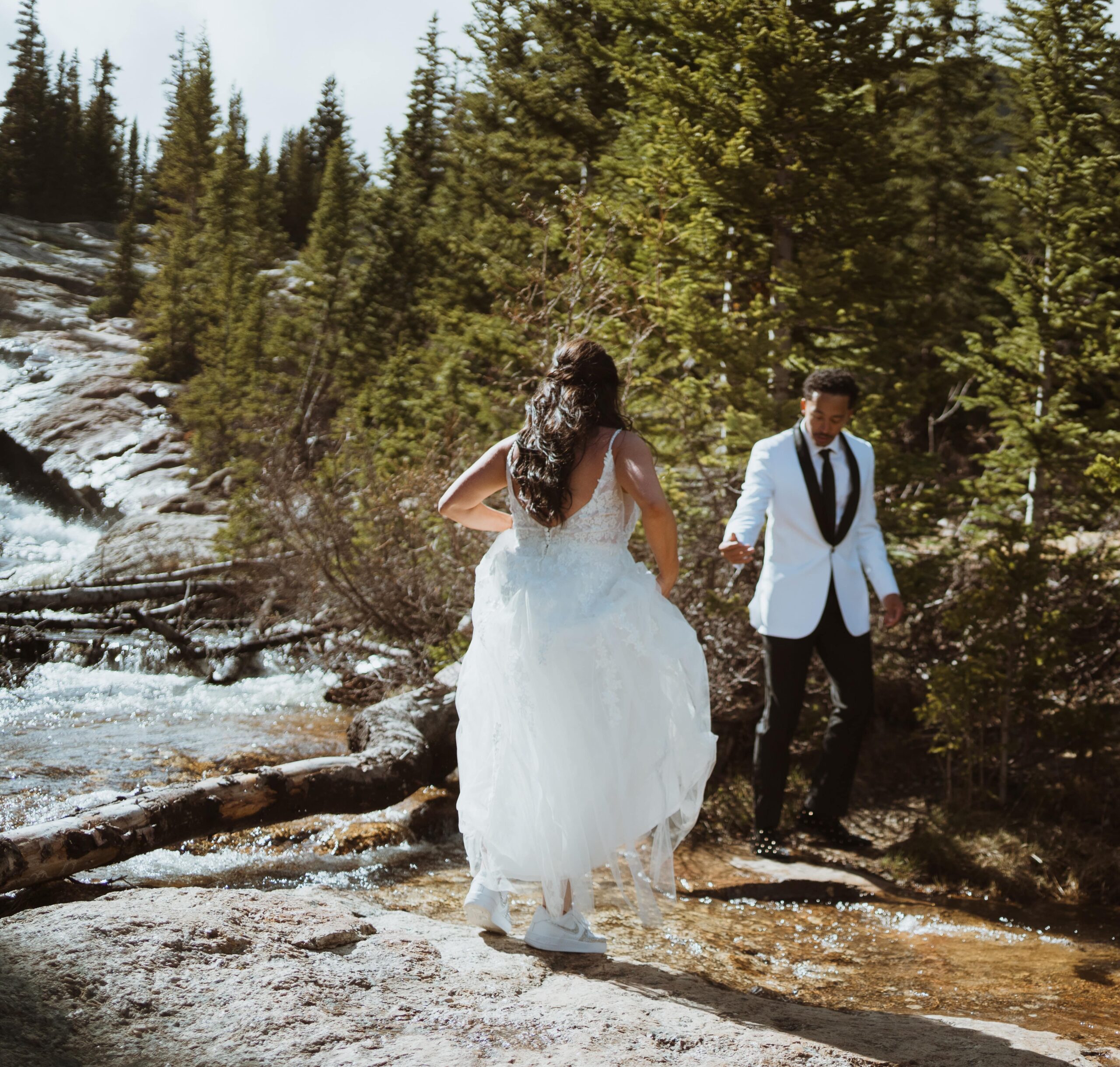 secret waterfall in breckenridge colorado. adventure elopement. the couple hiked in their wedding attire in june.