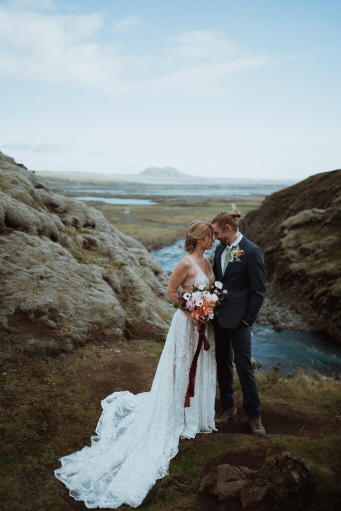 The couple hiked and off roaded on their elopement day. we went to waterfalls, canyons, and overlooks. black sand beach, the basalt columns, and more. elopement photography for adventurers.