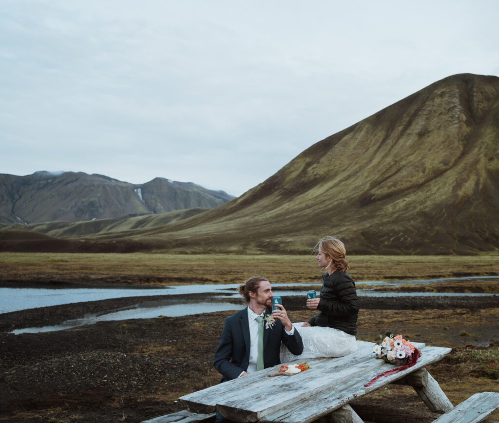 Off roading adventure in the Icelandic Highlands. The couple said their vows overlooking the mountains. Hiked to a hidden waterfall on the way. Stopped at a river for photos. Remote wedding locations. Adventure wedding photographer.